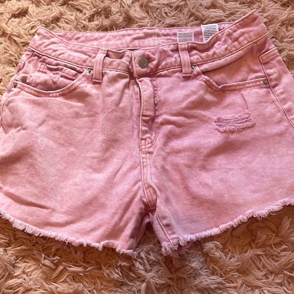 Light pink jean shorts.